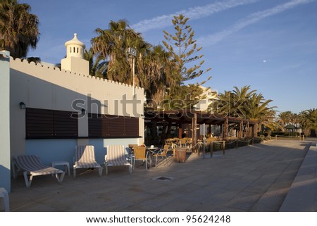 hotel bar and esplanade near the swimming pooll with parasol and sunbeds, Algarve, Portugal
