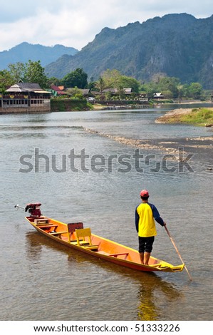 A man on the boat at River Song, Vang Vieng, Laos