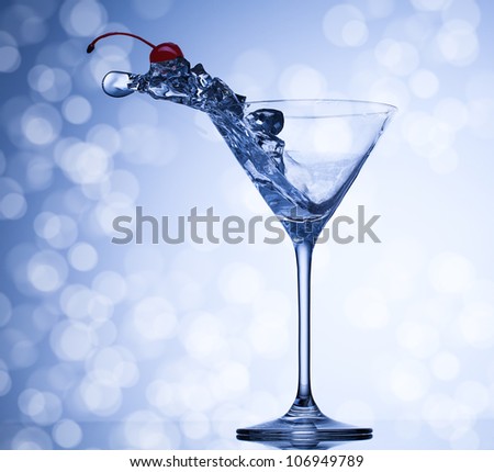 Martini with cherry splash in glass