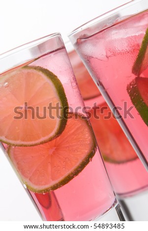 Cool, fresh, red cocktail with lime on a white background