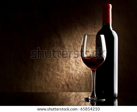 bottle with red wine and glass
