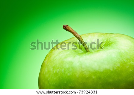 Green apple. Macro. on a green gradient