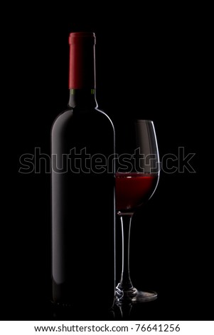 bottle with red wine and glass on a red gradient