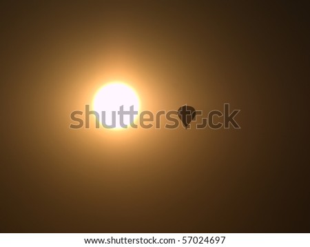 hot air balloon silhouette near the sun