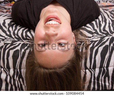 stock-photo-silly-upside-down-girl-against-zebra-pattern-109084454.jpg