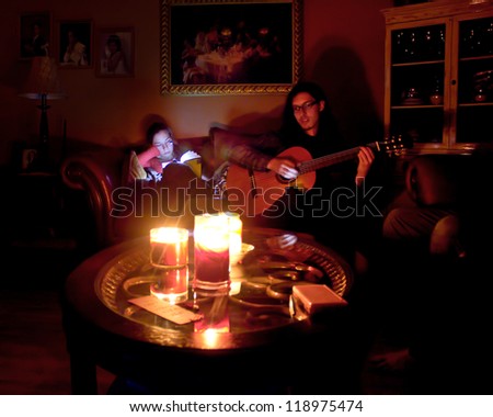 LONG ISLAND, NY- OCT 31: Couple in candlelit home due to Hurricane Sandy massive power outage in New York on Oct 31, 2012.  Sandy struck NY on Oct 29 leaving 1 million Long Islanders without power.