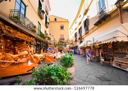 SORRENTO, ITALY - OCT 7: Street scene with shops and tourists in Sorrento Italy on Oct 7, 2010. Sorrento on the dramatic cliffs of the Amalfi Coast  is an important tourist destination