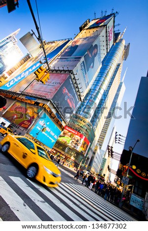 New York City, USA - Jan 6, 2013:  Yellow Taxi drives through Times Square in Midtown Manhattan on Jan 6, 2013. Times Square is a major commercial area known worldwide for it\'s lights and billboards.