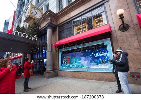 NEW YORK CITY - DEC 13: Spectators view holiday window display at Macy\'s Herald Square in NYC on Dec 13, 2013. Since the early 1870s Macys has been stunning visitors with holiday window displays