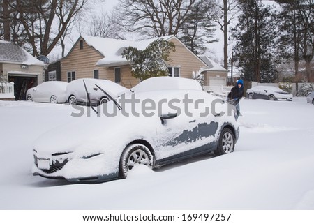 WEST HEMPSTEAD,  NY - JAN 3:  Snow covered car on Long Island, NY on Jan 3 2014 after snow storm. This powerful nor\'easter named Hercules caused blizzard conditions on Long Island.