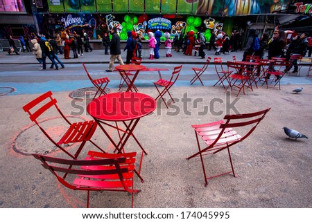 NEW YORK CITY - DEC. 13, 2013:  Seating area at plaza in busy Times Square NYC.  This popular pedestrian plaza is managed by The Times Square Alliance.