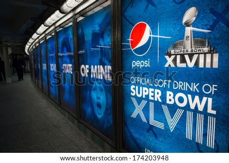NEW YORK CITY - JAN. 31, 2014:  Pepsi Cola Super Bowl advertisements in Times Square NYC subway station.  Pepsi is the official sponsor of the Super Bowl XLVIII Halftime Show.