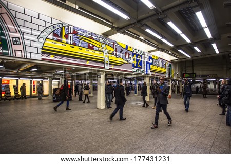 NEW YORK CITY - JAN 31, 2014:  View of Times Square subway station in midtown Manhattan with travelers visible. New York City Subway is the busiest rapid transit rail system in the United States.