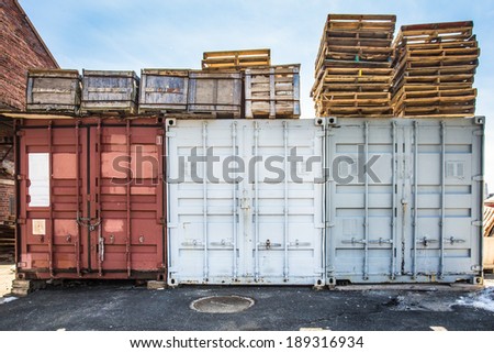 Industrial storage containers and skids in shipyard
