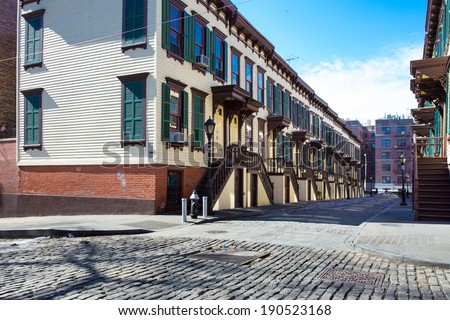 NEW YORK CITY - MARCH 8, 2014:  Row houses along historic Sylvan Terrace in Manhattan.  This landmark cobblestone street is in the Washington Heights section of NYC