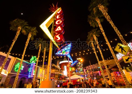 LAS VEGAS, NV - MAY 7, 2014: View of Fremont Street with vintage lit Vegas sign in Las Vegas Nevada.
