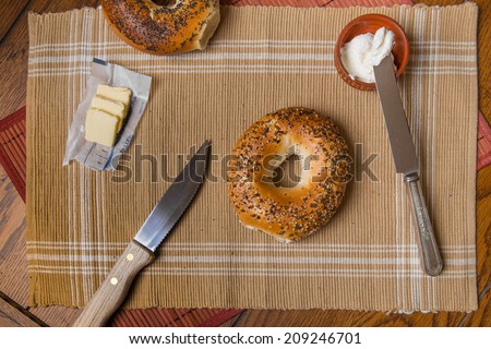 New York style bagels in setting with cream cheese and butter