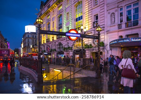 LONDON, UNITED KINGDOM - OCTOBER 8, 2014:  View of London Piccadilly Circus West End district seen at night with people and Underground station in view.