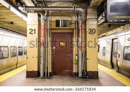 NEW YORK CITY - MARCH 13, 2015:  Scene with utility door and train from underground subway platform at Pennsylvania Station in Manhattan