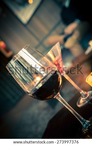 Wine and cocktail glasses in lounge with warm light