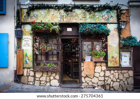 PARIS, FRANCE - OCTOBER 9, 2014:  Tourism point of interest  een from street in Montmartre Paris, France of charming cafe.