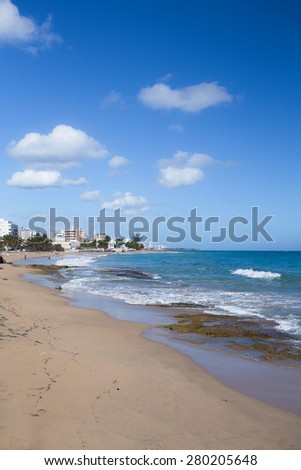 SAN JUAN, PUERTO RICO - MARCH 28, 2015:  view of beach with Condado Hotels in the distance seen from Ocean Park in San Juan.