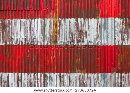 Patriotic red and whites stripes from segment of painted American  flag on corrugated metal
