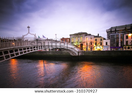 Vintage toned image of historic Ha\'penny Bridge over the River Liffey in Dublin Ireland