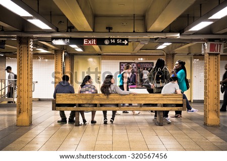 NEW YORK CITY - SEPTEMBER 24, 2015:  View of underground subway station at 14th Street in New York City with people waiting.
