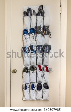 Various athletic shoes on pockets of door organizer