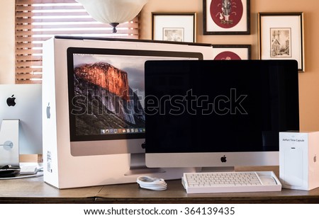 NEW YORK CITY - JANUARY 12, 2016:  New Apple iMac home computer with box and AirPort Time Capsule in home setting.