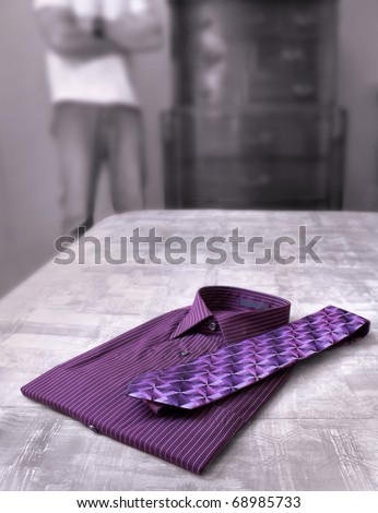 A man\'s dress shirt and tie with a man in the background
