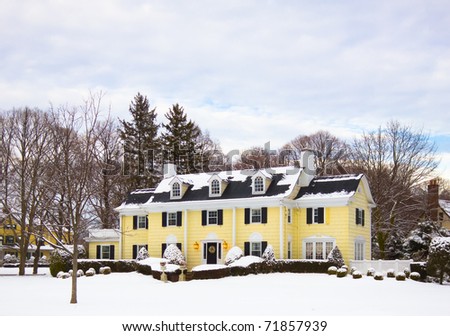 A luxury home covered in snow on a winter day