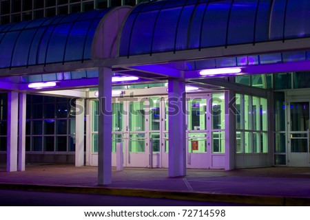 Exterior entrance to office building lit with purple and green