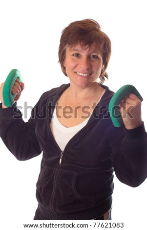 A older woman in a sweat jacket lifting hand weights