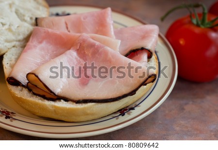 A simple lunch scene of deli sliced Virginia Ham on a roll