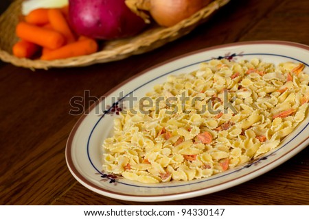 Dried pasta with vegetables in the background during meal preparation