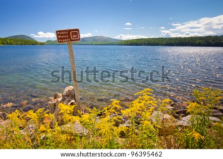 Landscape with sign prohibiting swimming in public water supply reservoir