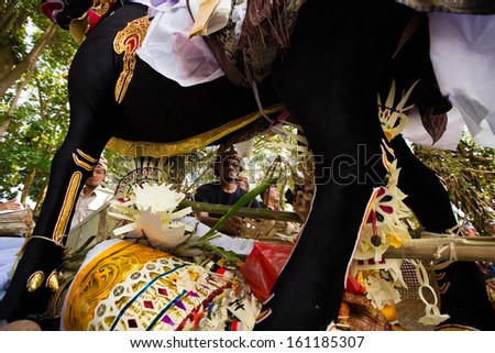 UBUD, BALI, INDONESIA - NOV 1: Man works on ceremonial bull during cremation of the Queen on November 1, 2013 in Ubud, Bali.