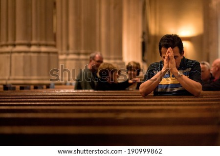 NEW YORK - OCT 20: Man prays at St Patrick\'s Cathedral on October 20, 2011 in New York City. The Cathedral will undergo a massive five-year, three-phase, $175 million renovation