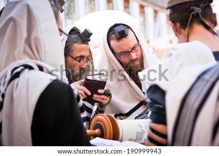JERUSALEM - MAY 16: Orthodox Jewish men pray at western wall on May 16, 2011. The Western wall is an important Jewish religious site located in the Old City of Jerusalem