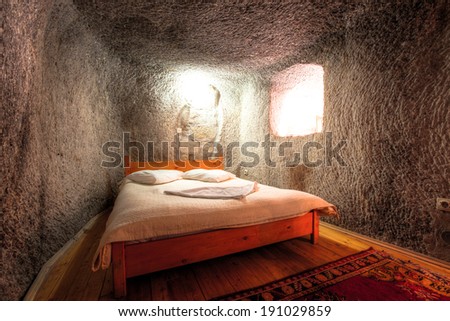 CAPPADOCIA, TURKEY - JUN 16: Cave bedroom on June 16, 2011 in Cappadocia, Turkey. The best historic mansions and cave houses for tourist stays are in Urgup, Goreme, Guzelyurt and Uchisar.