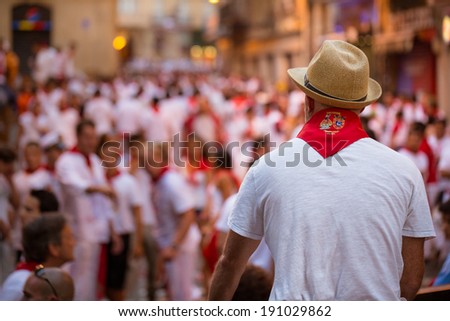 PAMPLONA - JULY 10: Man Watches San Fermin Running of the Bulls on July 10, 2013 in Pamplona, Spain.
