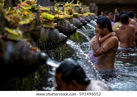 Man washes his face at Tirtha Empul water temple