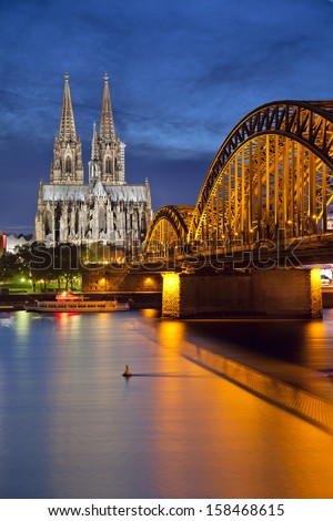 Cologne, Germany. Image Of Cologne With Cologne Cathedral And Hohenzollern Bridge Across The Rhine River.