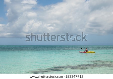 Woman kayaking on Grace Bay in Turks & Caicos