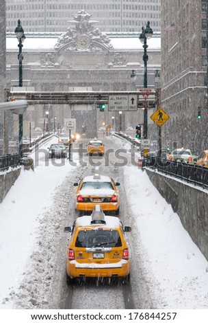 New York, NY, USA - February 13, 2014 - Taxis on Park Avenue in Manhattan heading towards Grand Central Terminal during Winter Storm Pax. The storm blanketed New York CIty with over a foot of snow.