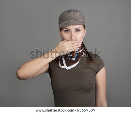 Young woman covering her mouth with her hand