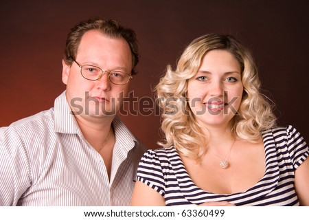 family photo of young matrimonial pair is in a studio