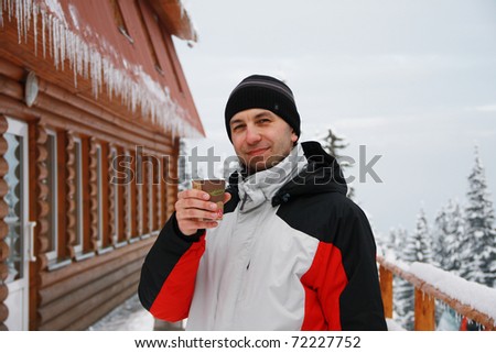Portrait of young man of skier with glass of Mulled wine in hand, Carpathian Mountains, Dragobrat, Ukraine